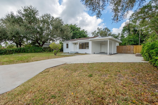 ranch-style house with a carport and a front yard