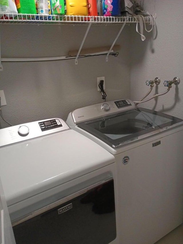 washroom featuring washing machine and dryer