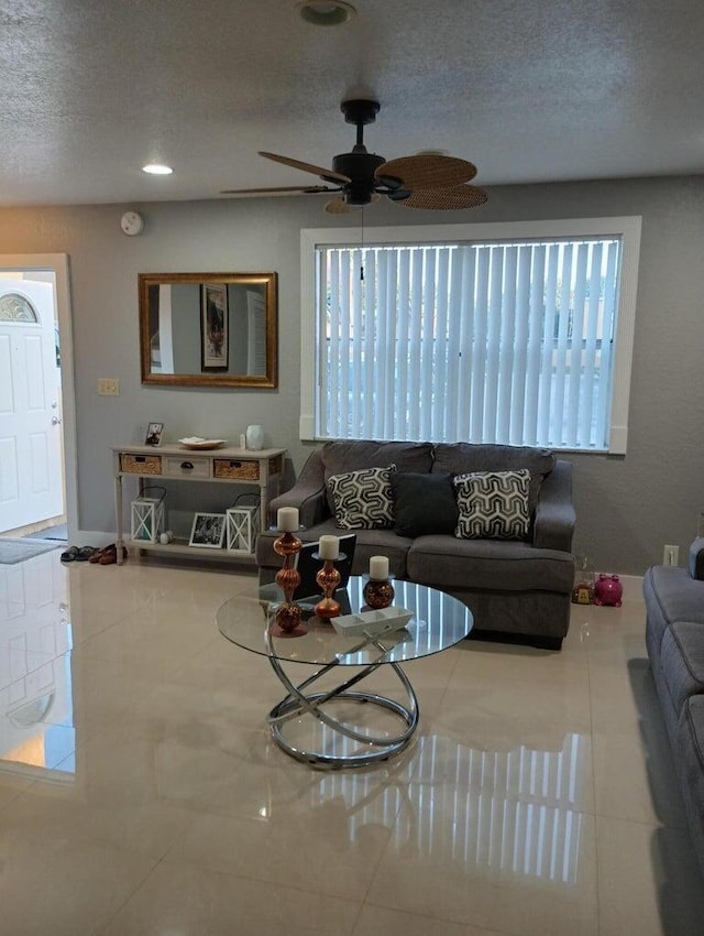 living room featuring tile patterned floors, plenty of natural light, and a textured ceiling