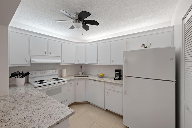 kitchen featuring white cabinetry, light tile patterned floors, and white appliances