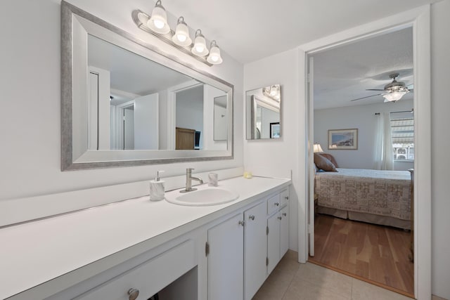 bathroom with a textured ceiling, vanity, tile patterned floors, and ceiling fan