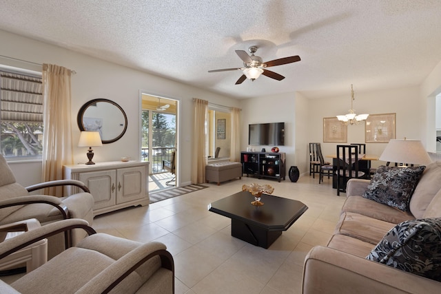 tiled living room with ceiling fan with notable chandelier and a textured ceiling