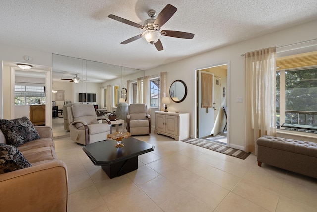 tiled living room with a textured ceiling and ceiling fan