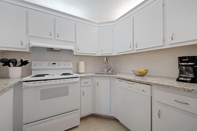 kitchen with white appliances, white cabinets, sink, light tile patterned floors, and tasteful backsplash