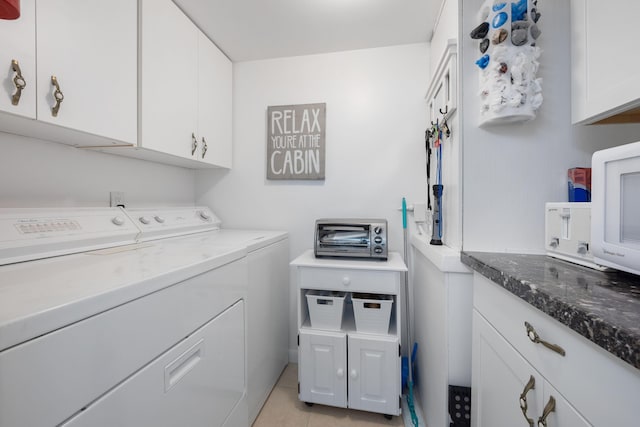 clothes washing area featuring independent washer and dryer and light tile patterned floors