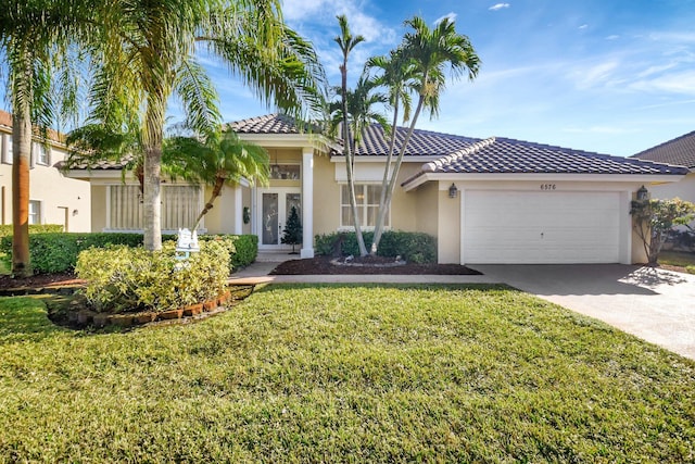 mediterranean / spanish-style home with a front lawn and a garage