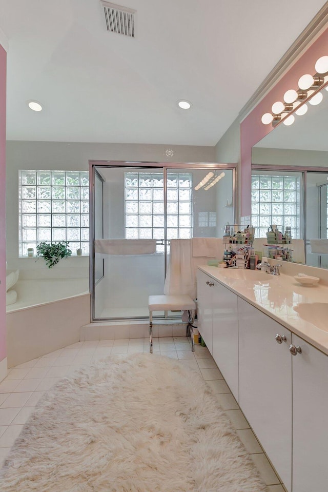 bathroom featuring vanity, tile patterned floors, and plenty of natural light