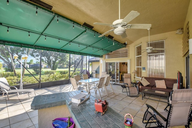 view of patio / terrace with a lanai, outdoor lounge area, and ceiling fan