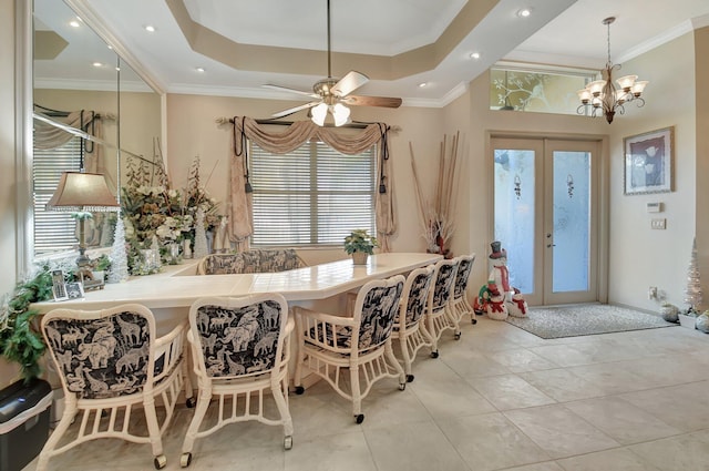 tiled dining space featuring ceiling fan with notable chandelier, ornamental molding, and french doors