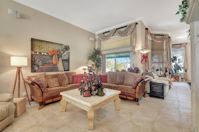 living room featuring light tile patterned floors, a wood stove, and ornamental molding