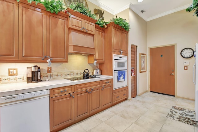 kitchen featuring white appliances, premium range hood, ornamental molding, and backsplash