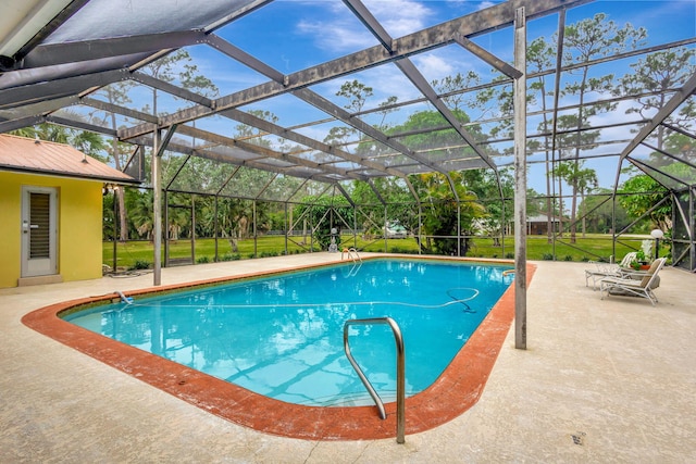 view of swimming pool featuring a patio area and a lanai