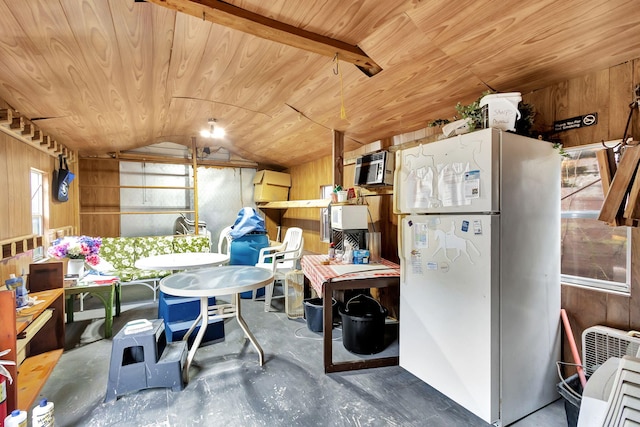 interior space featuring wooden walls, white fridge, and wooden ceiling