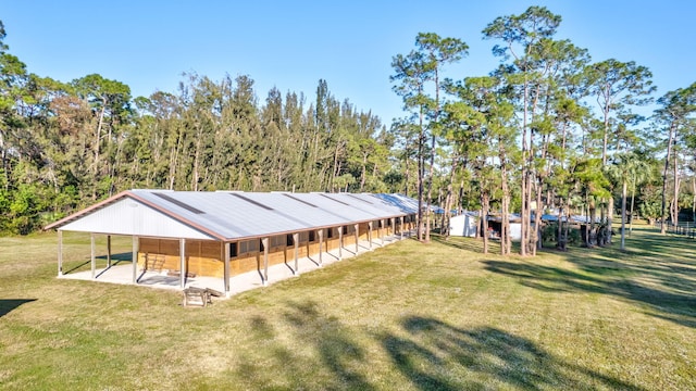 rear view of property featuring an outbuilding