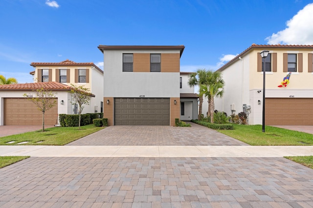 view of front of property featuring a garage and a front lawn