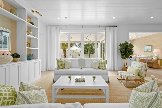 living room featuring light hardwood / wood-style flooring and wooden ceiling