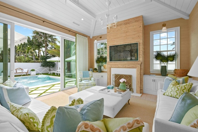 sunroom with an inviting chandelier, vaulted ceiling with beams, and wooden ceiling