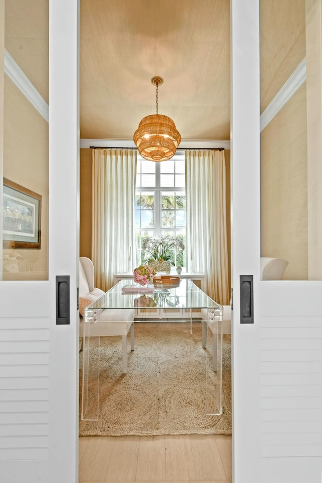 interior space with an inviting chandelier and ornamental molding