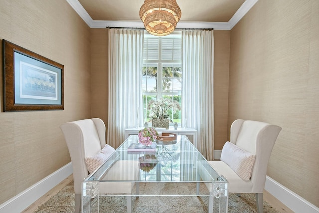 dining room with crown molding and hardwood / wood-style flooring