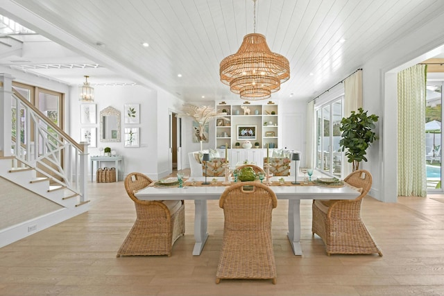 dining room featuring wood ceiling, a chandelier, and light hardwood / wood-style floors