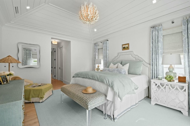 bedroom with crown molding, high vaulted ceiling, hardwood / wood-style floors, and a notable chandelier