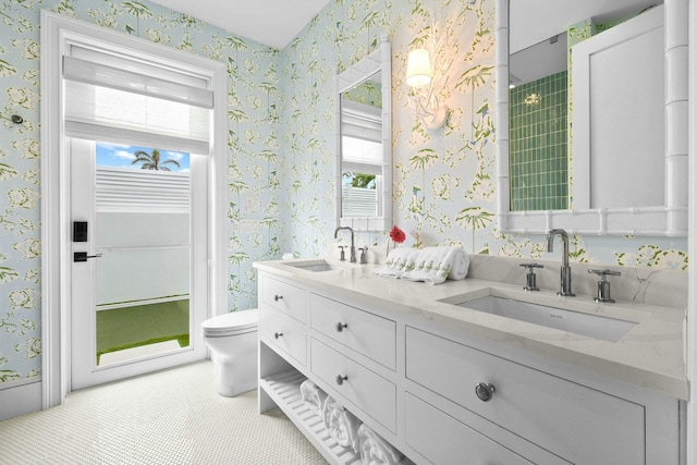 bathroom featuring vanity, tile patterned flooring, a wealth of natural light, and toilet