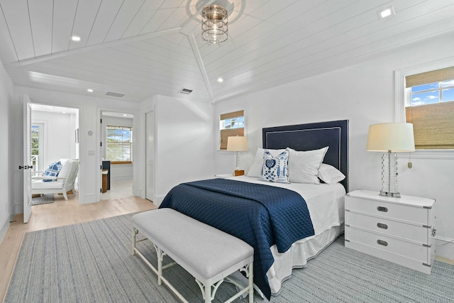 bedroom with vaulted ceiling, wooden ceiling, and light wood-type flooring