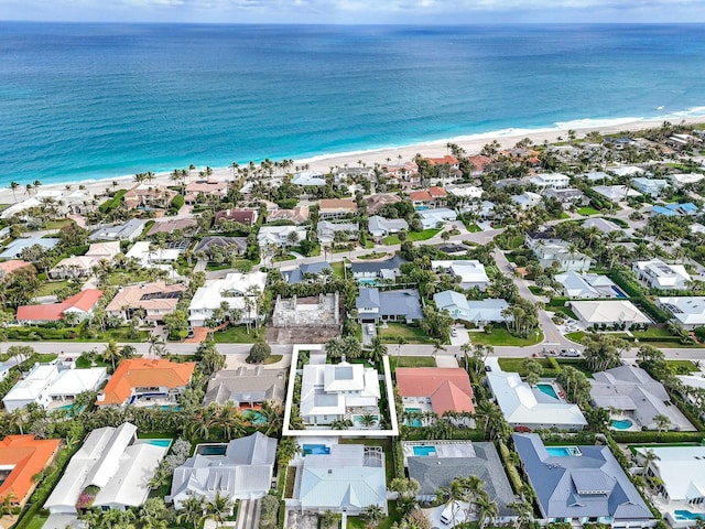 aerial view with a water view and a beach view