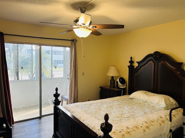 bedroom featuring a textured ceiling, access to outside, ceiling fan, and dark hardwood / wood-style floors