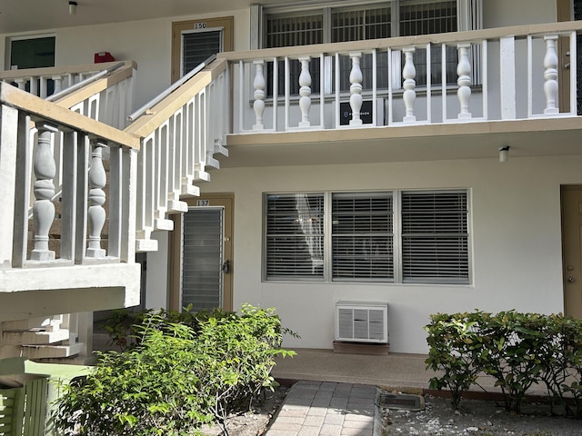 view of exterior entry featuring a balcony