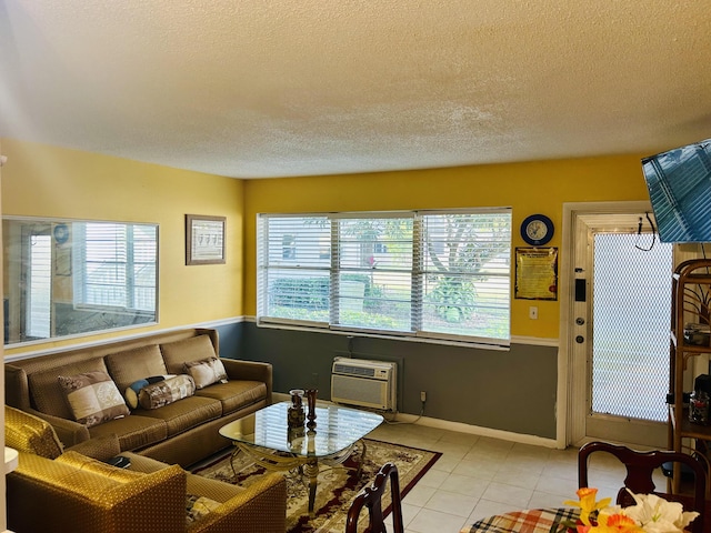 living room with a wall unit AC, plenty of natural light, light tile patterned floors, and a textured ceiling