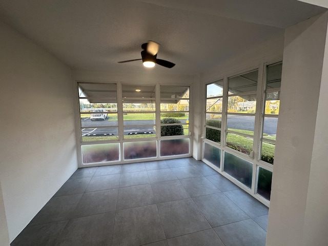 unfurnished sunroom with ceiling fan and a healthy amount of sunlight