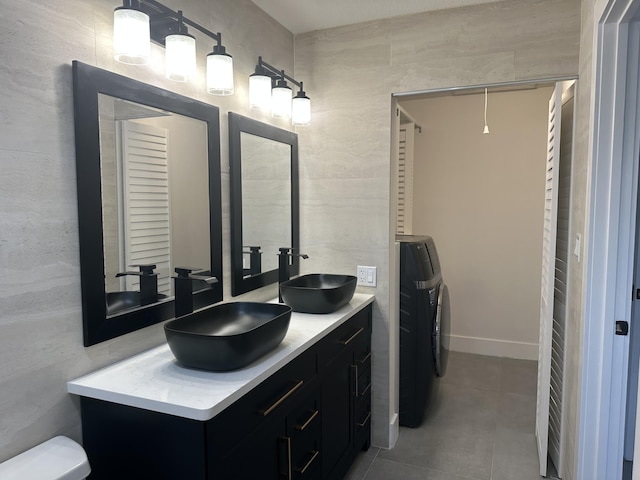 bathroom featuring vanity and washer / clothes dryer