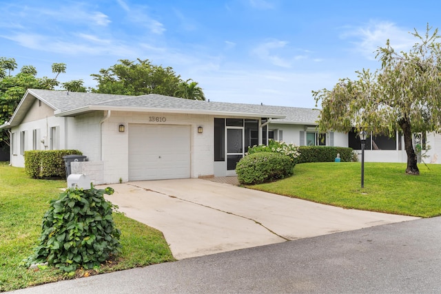 single story home featuring a front yard and a garage