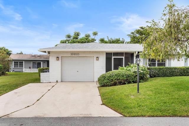 single story home featuring a garage and a front lawn