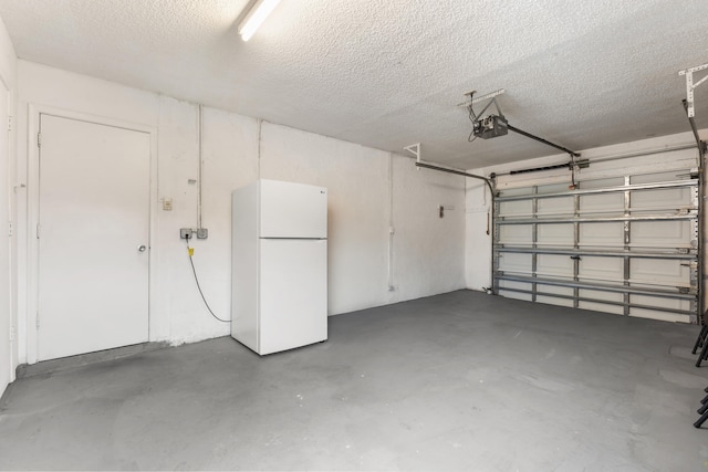 garage with white fridge and a garage door opener