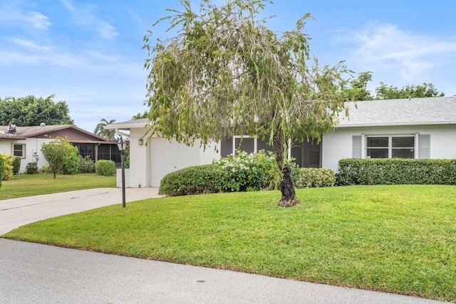 view of front facade with a front yard and a garage