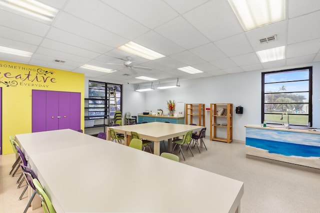 playroom with a drop ceiling and ceiling fan