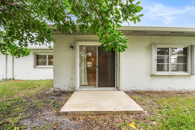 entrance to property featuring a patio