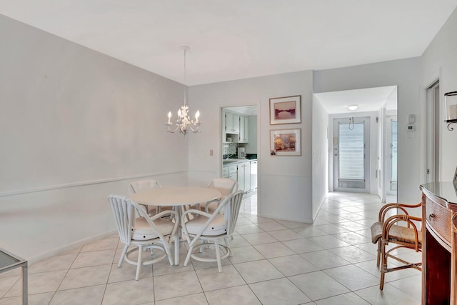 dining space with a notable chandelier and light tile patterned flooring