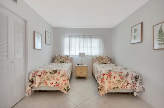 tiled bedroom featuring a closet