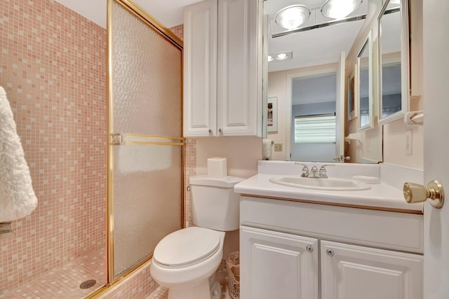 bathroom featuring vanity, toilet, and an enclosed shower