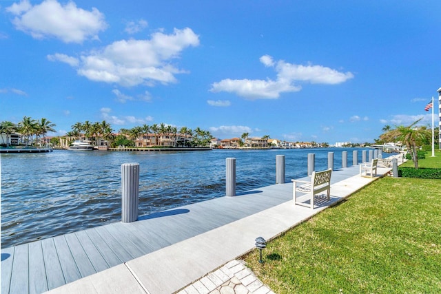 view of dock featuring a yard and a water view