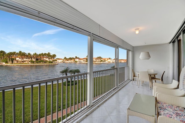 unfurnished sunroom featuring a water view