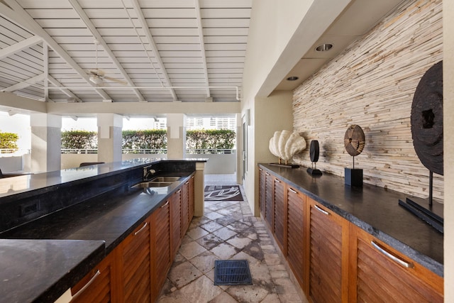 bar with vaulted ceiling with beams, ceiling fan, wooden ceiling, and sink