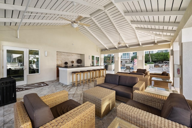 view of patio / terrace with a bar, an outdoor hangout area, and ceiling fan