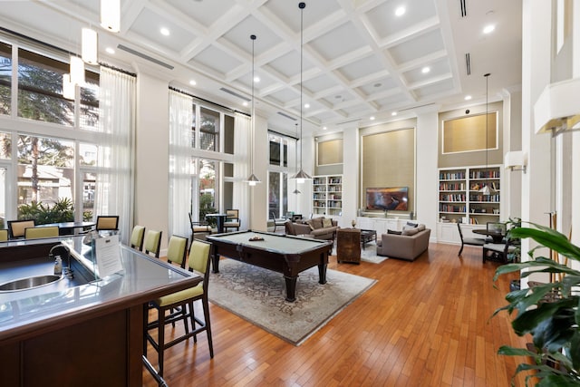 rec room featuring sink, coffered ceiling, a towering ceiling, light hardwood / wood-style floors, and pool table