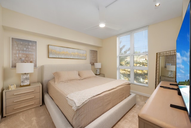 bedroom featuring light carpet and ceiling fan