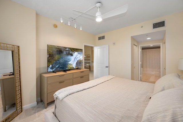 carpeted bedroom with ceiling fan and connected bathroom