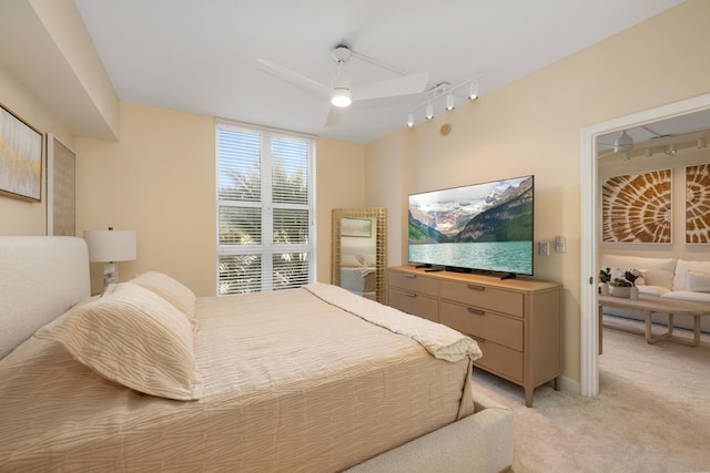 bedroom with ceiling fan and light carpet